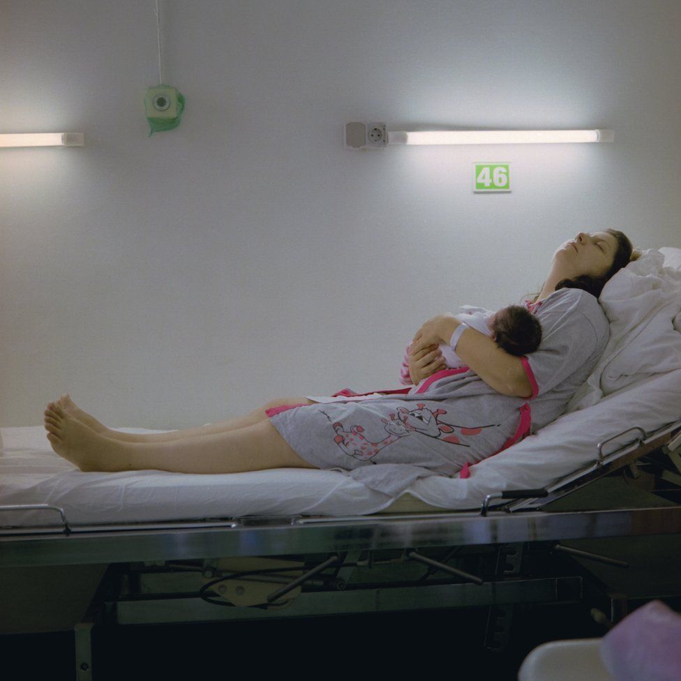 Roxana rests with her newborn baby at a hospital in Bucharest.