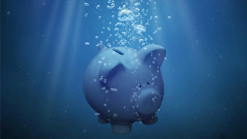 Piggy bank sinking in water