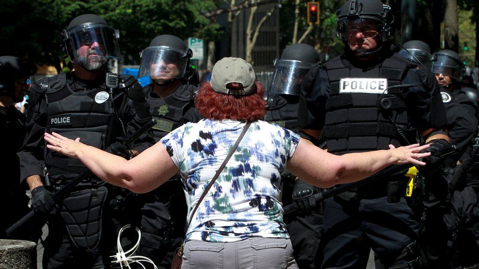 A counter-protester argues with police during a rally by the Patriot Prayer group in Portland, Oregon, 4 August 2018