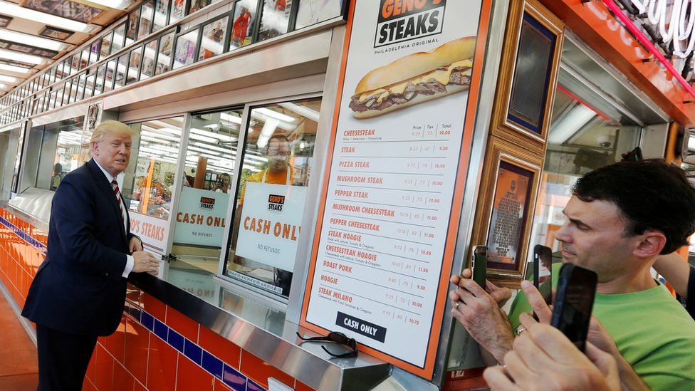 Donald Trump waits for his order on the campaign trail in Philadelphia