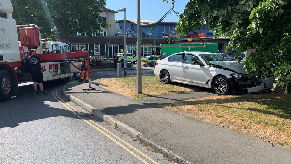 Fire engine and a damaged, white BMW at Withybush Hospital