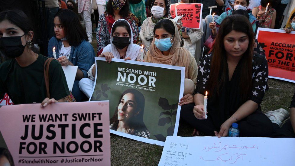 Women rights activists hold placards and candles during a protest rally against the brutal killing of Noor Mukadam, the daughter of a former Pakistani diplomat who was found murdered at a house in Pakistan's capital on July 20, in Islamabad on September 22, 2021.
