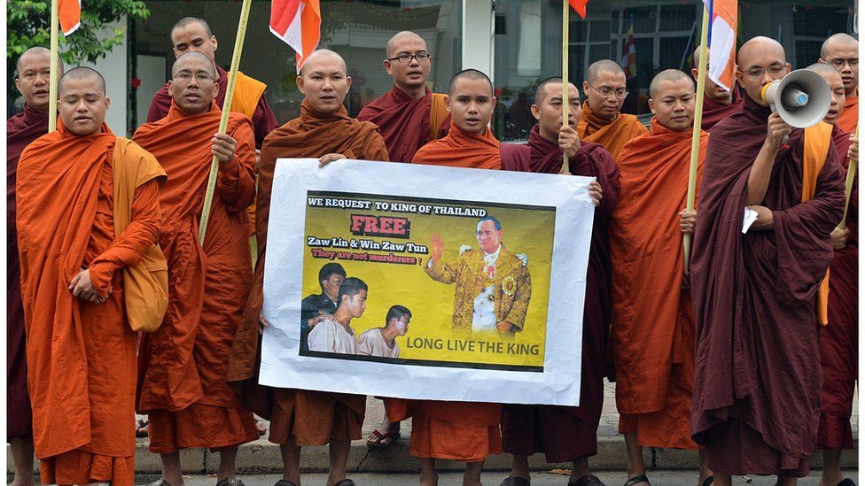 Buddhist monks from Myanmar hold a poster as they demonstrate outside the Thai embassy in Sri Lanka's capital Colombo