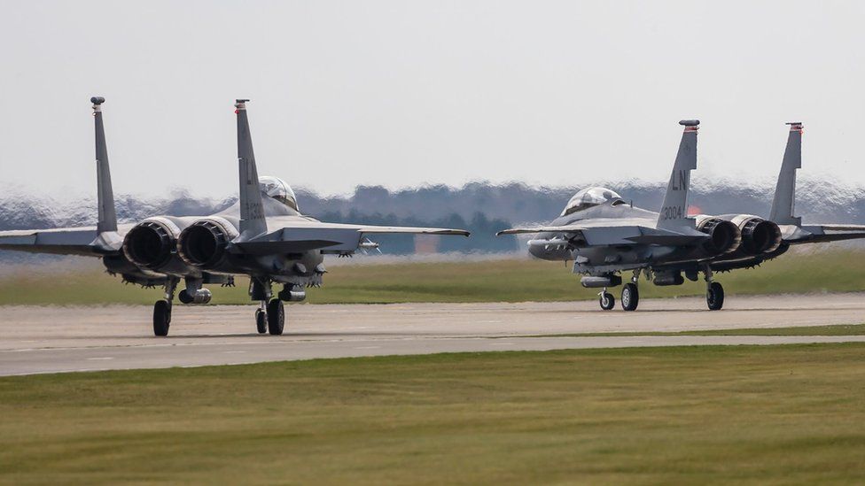 Two F-15E Strike Eagles of the US Air Force line up to take off from RAF Lakenheath