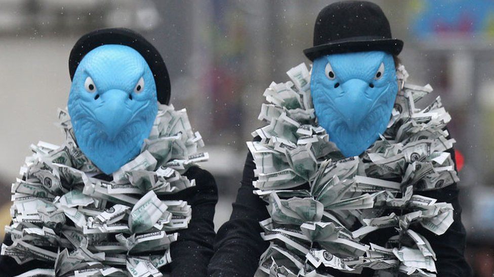 Protestors dressed as eagles protest against Barclays' senior management pay at the company's 2012 AGM