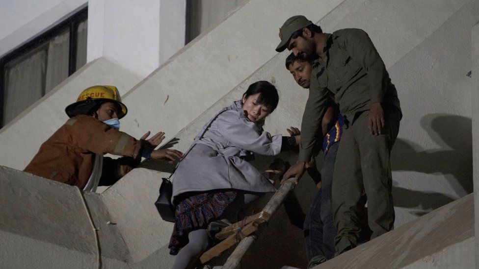 Rescue workers save people from a building fire in Pakistan