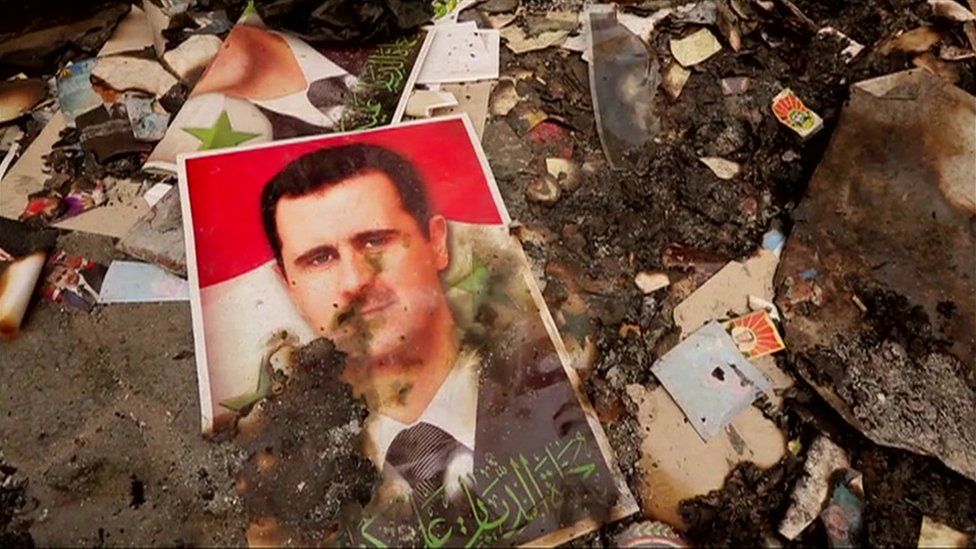 Charred photo of Assad