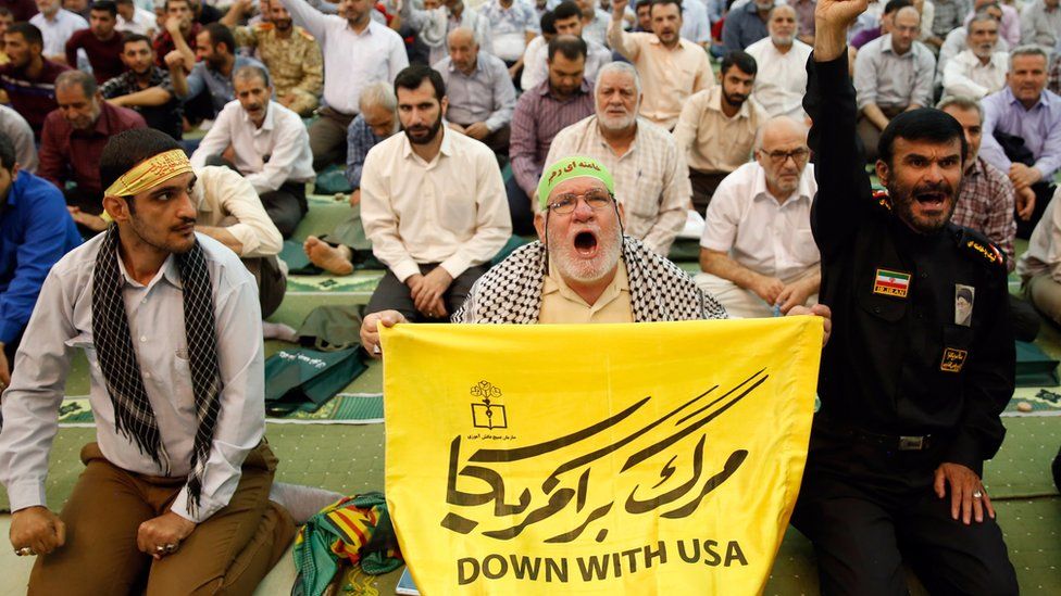 An Iranian man holds an anti-US placard and shouts slogans during Friday prayers at the Imam Khomeini Mosque in Tehran, Iran, 19 July 20