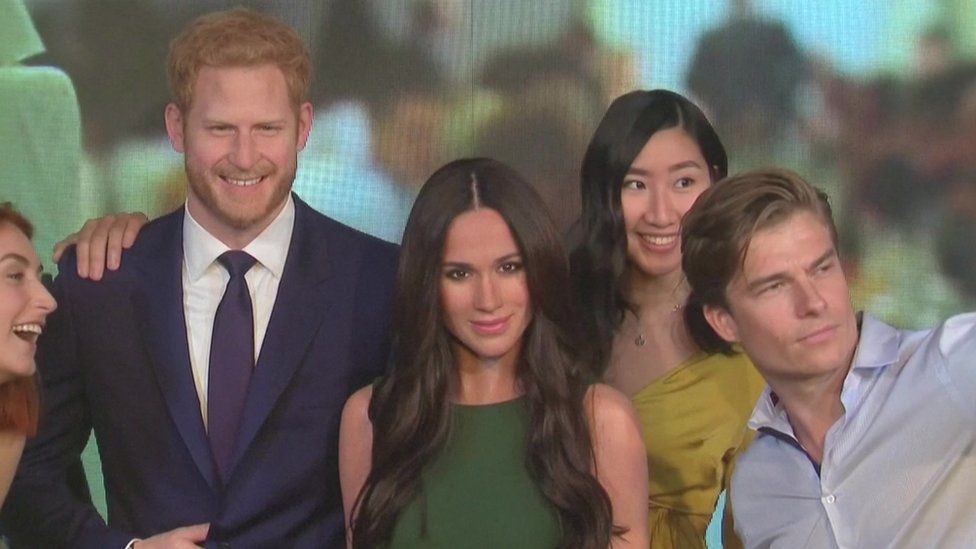 Visitors take selfies with wax figures of Harry and Meghan in Madame Tussauds London