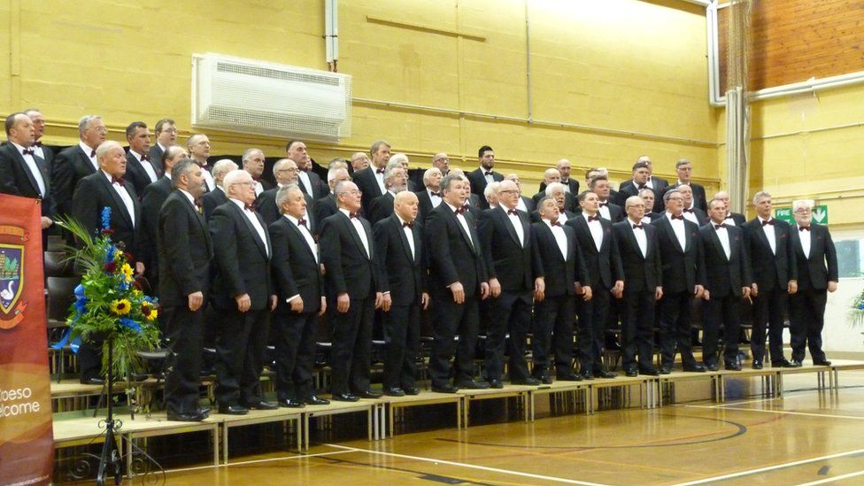 Caldicot Male Voice Choir standing together at a performance