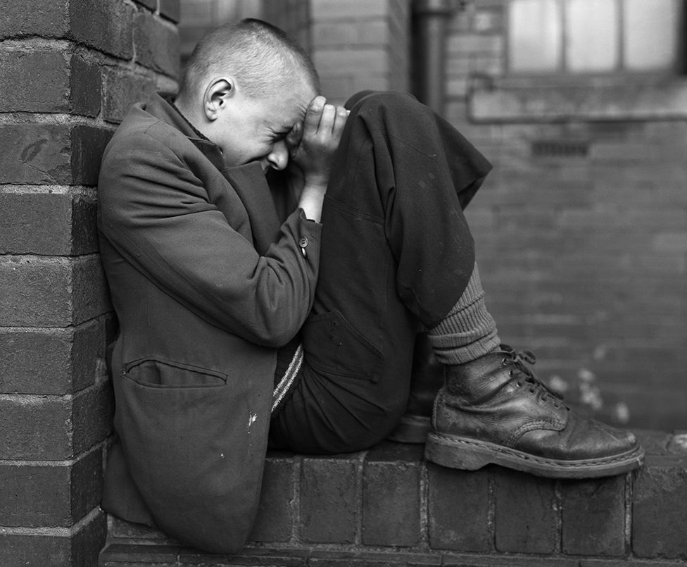 Youth on wall, Jarrow, Tyneside, 1975