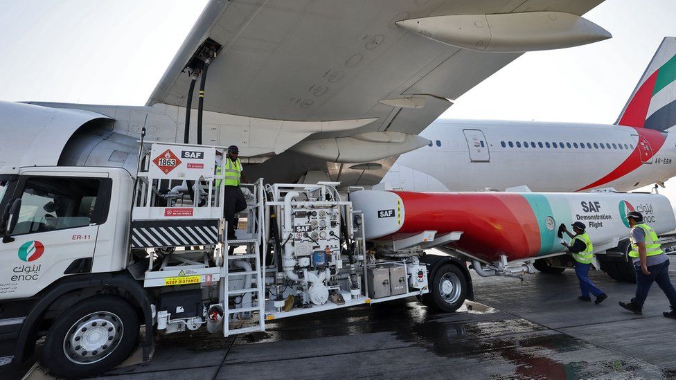 Ground crews prepare an Emirates Boeing 777-300ER aircraft, powering one of its engines with a hundred per cent Sustainable Aviation Fuel (SAF), in Dubai, on January 30, 2023