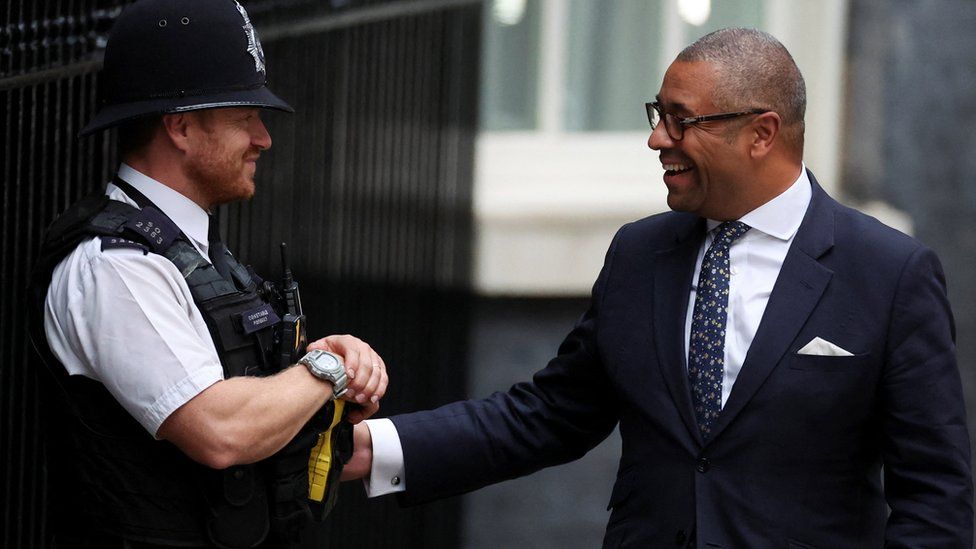 James Cleverly talking to a policeman outside 10 Downing Street