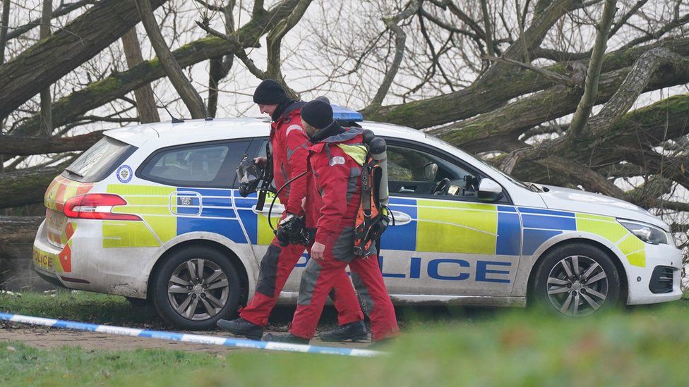 Police divers arrive at the scene in Babbs Mill Park in Kingshurst, on 13 December