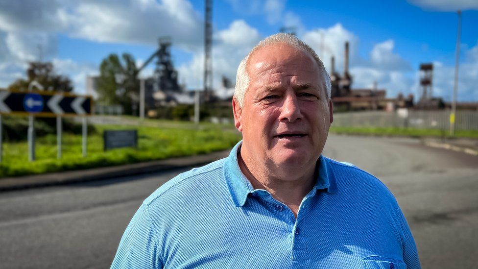 Malcolm Sibthorpe standing in front of Port Talbot steel works