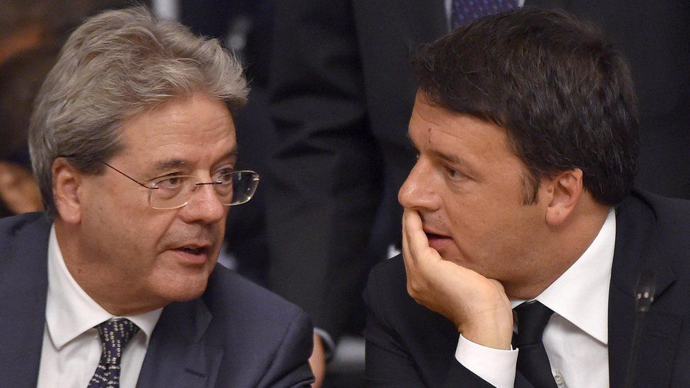 Matteo Renzi and Paolo Gentiloni talk during a conference of the Italian ambassadors at the Farnesina"s Palace, in Rome, in 2015