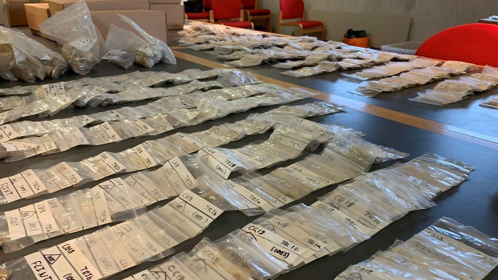 Material in bags laid out on a table