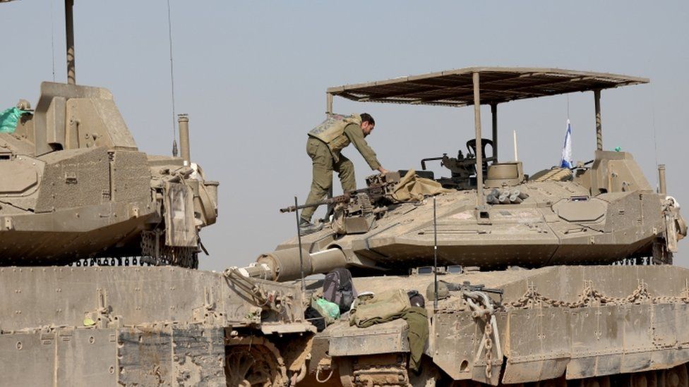 Israeli soldiers and their tanks near southern Gaza