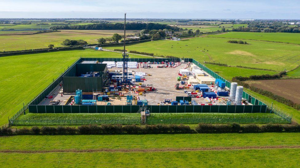 A fracking site next to a green field