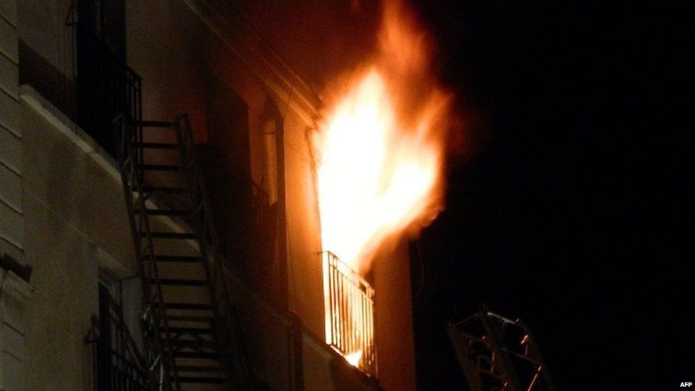 Flames billow out of a window at an apartment building in Paris. Photo: 2 September 2015