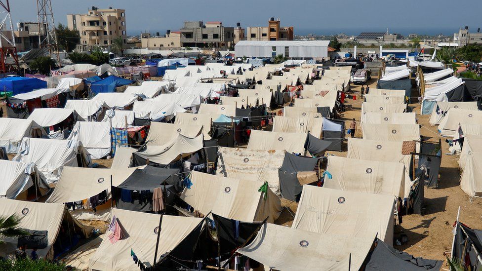 Palestinian take shelter in a tent camp at a United Nations-run centre in Khan Younis after Israel's call for more than 1 million civilians in northern Gaza to move south 23 October 2023