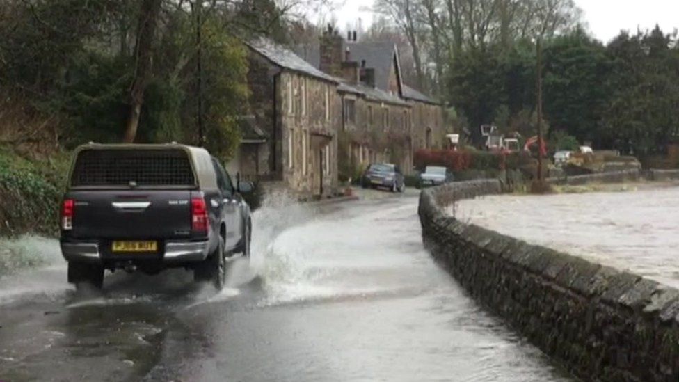 Car drives through water