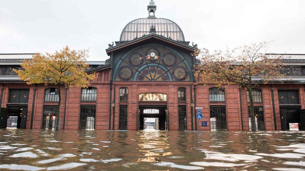 Flood waters surround a building at Hamburg's Fish Market district