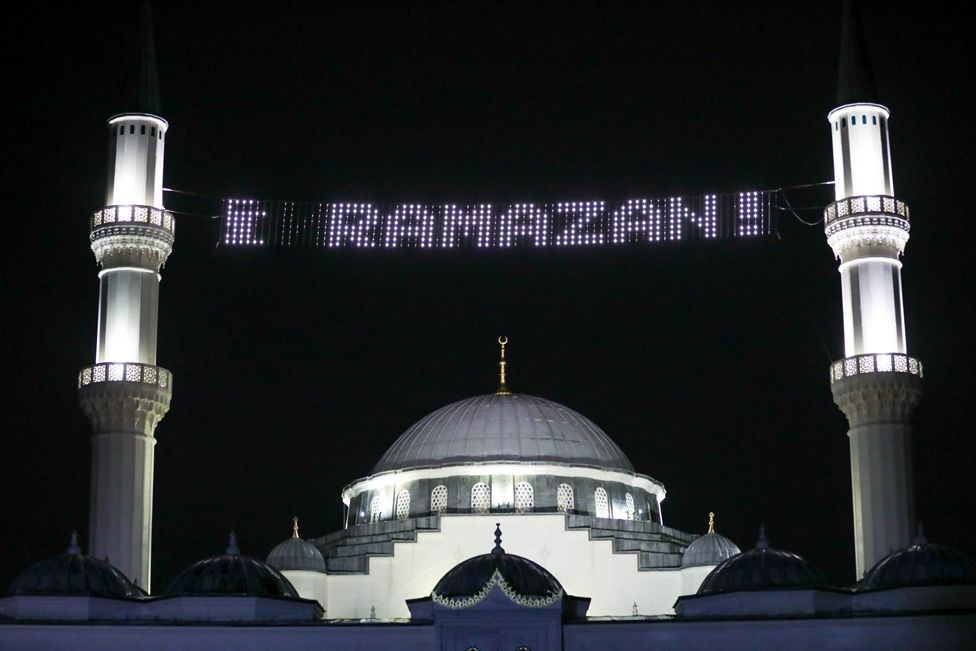A mosque with an electronic sign saying Ramazan