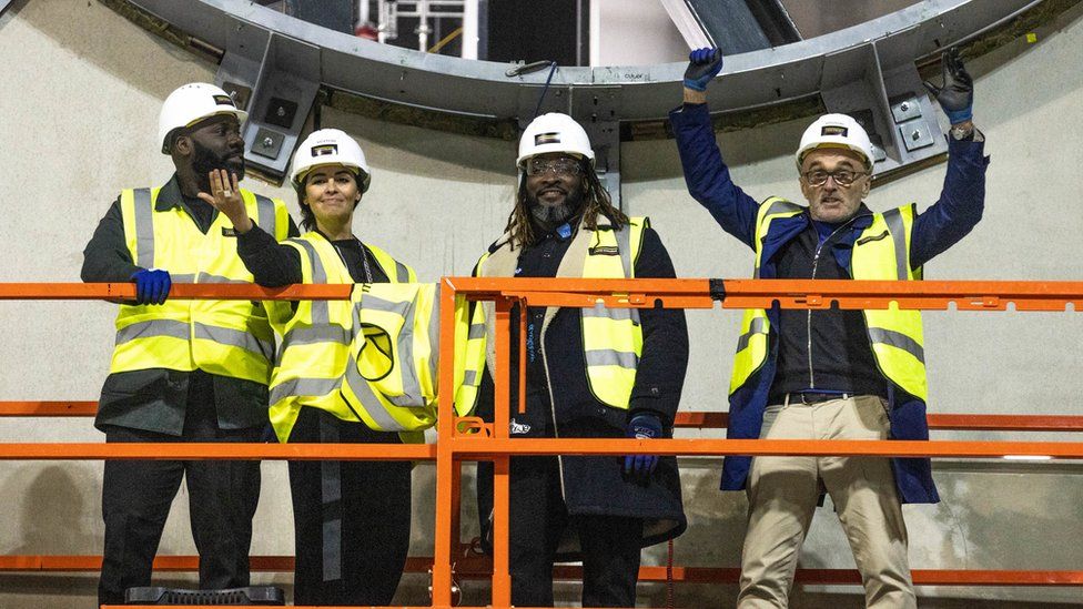 Danny Boyle (right) and collaborators Michael Asante, Es Devlin and Kenrick Sandy in the under-construction Factory International