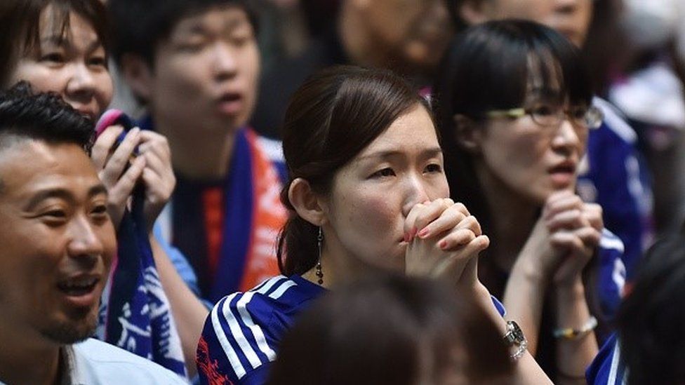 Japanese football supporters react as they attend a public screening in Tokyo on July 6, 2015, of the 2015 FIFA Women's World Cup final between Japan and USA being played in Vancouver, British Columbia.