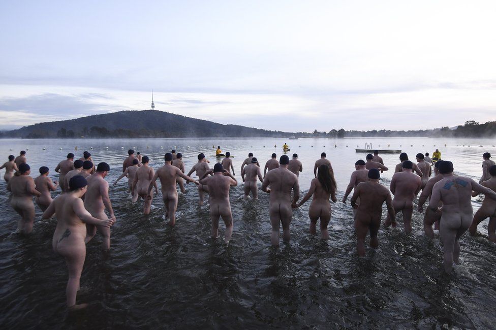 Swimmers take part in the Winter Solstice Nude Charity Swim in Canberra