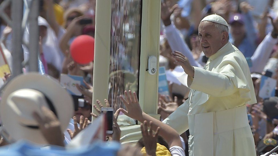 Pope Francis waves from the popemobile upon arrival for an open-air mass at Samanes Park in Guayaquil, Ecuador, on July 6, 2015.