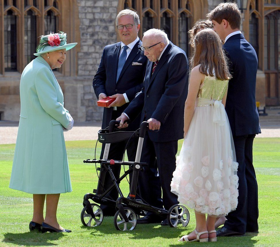The Queen talks Captain Sir Tom Moore and his family in the grounds of Windsor Castle