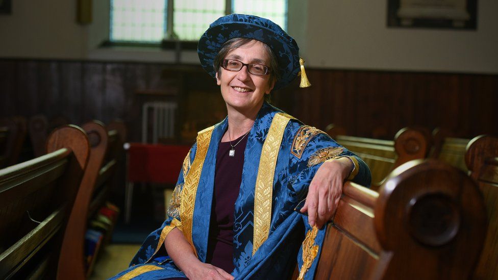 Prof Helen Pankhurst in her blue and gold chancellor gown