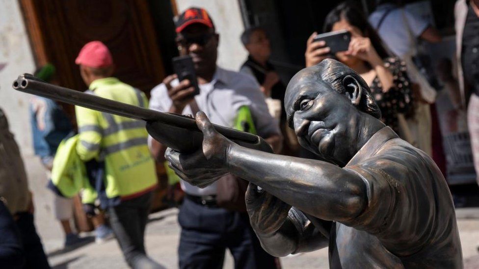 View of an art installation by Chilean artist Nicolas Miranda representing Spain's Emeritus King Juan Carlos taking aim at the iconic 'Oso y el Madrono' statue in central Madrid, Spain, 25 April 2023.