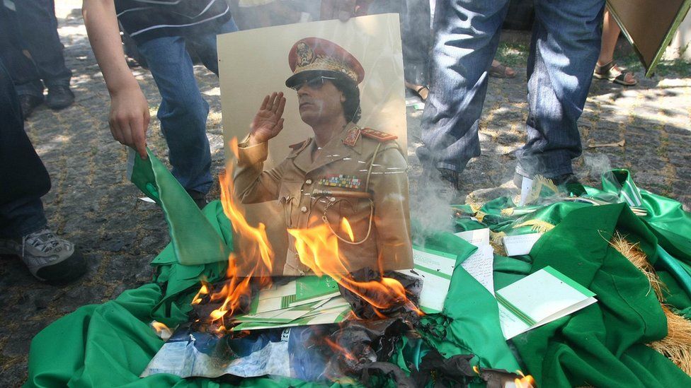A photo of Muammar Gaddafi is destroyed in 2011