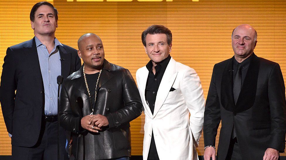 Shark Tank cast members Mark Cuban, Daymond John, Robert Herjavec, and Kevin O'Leary speak onstage at the 2014 American Music Awards