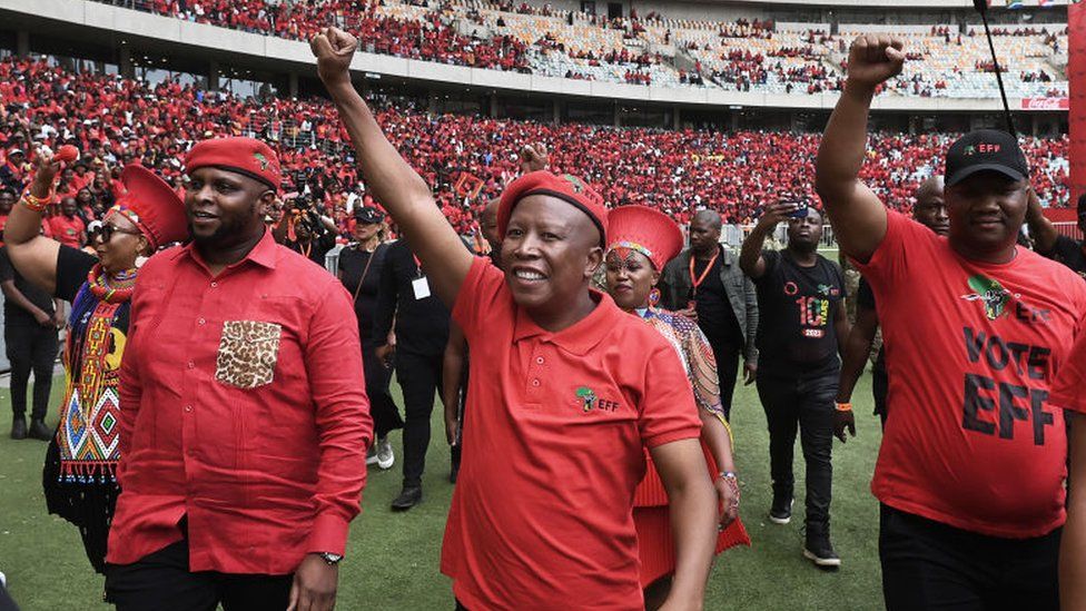 Julius Malema, leader of the Economic Freedom Fighters (EFF), centre, salutes the crowd during the Economic Freedom Fighters party manifesto launch in Durban, South Africa, on Saturday, Feb. 10, 2024