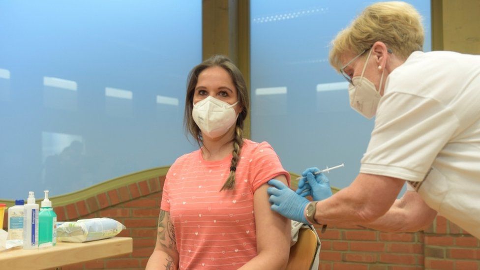 Nursery teacher, Kathy Wienecke, receives her first dose of AstraZeneca vaccine from nurse Susanne Kugel, amid the spread of the coronavirus disease (COVID-19), in Grevesmuehlen, Germany