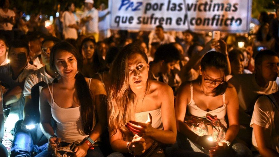 Demonstrators light candles during a march for peace in Cali, Colombia, on 5 October