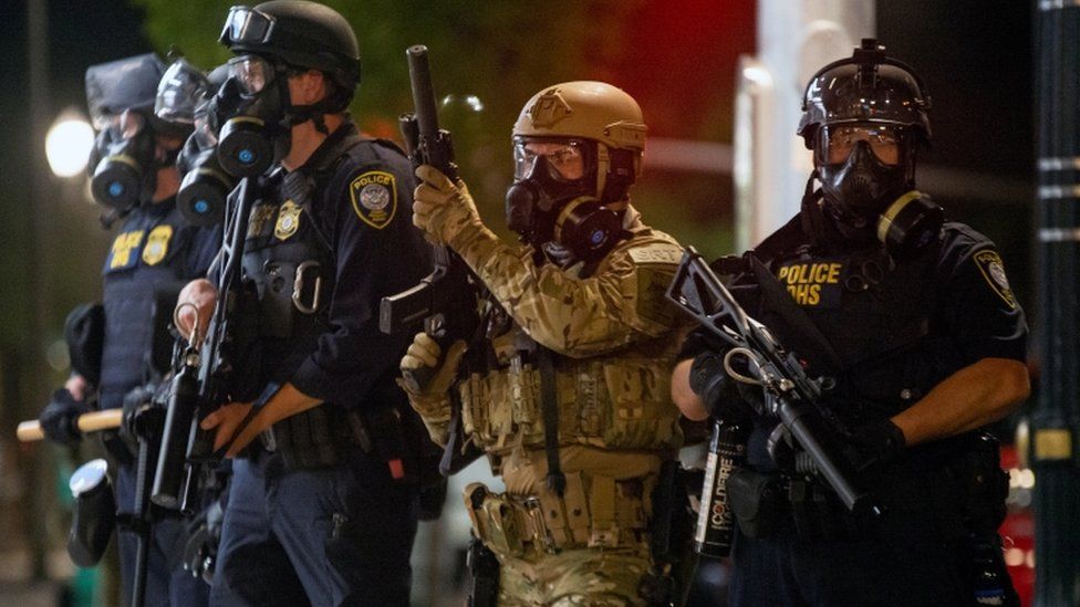 Federal officers face protesters in Oregon on 18 July