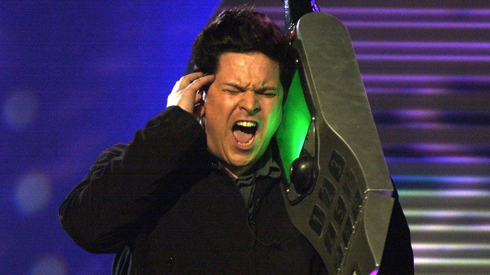 Dom Joly with a huge mobile phone