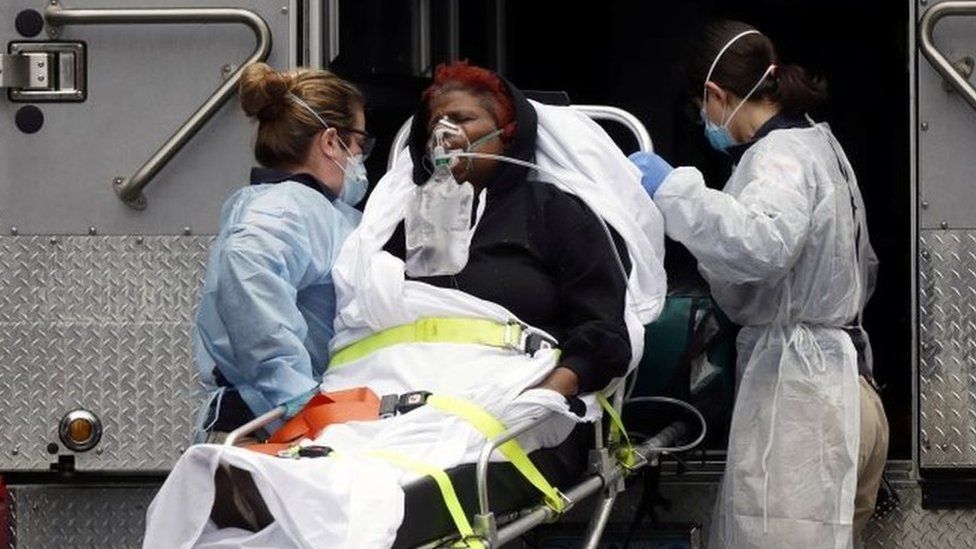 Medics bring a sick patient to an ambulance in New York City. Photo: 28 March 2020