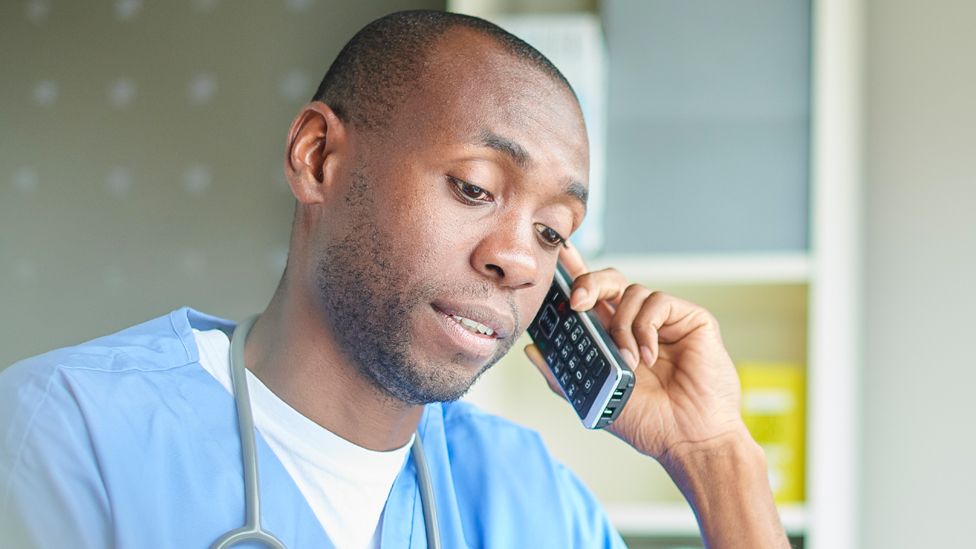 Stock image of a doctor using a phone