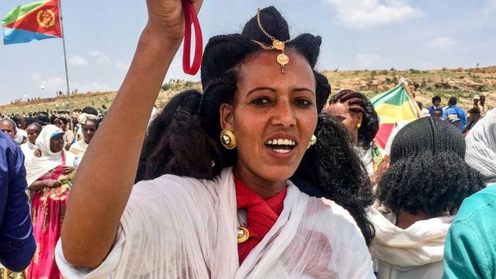 An Eritrean woman sings after crossing the boarder to attend the reopening border ceremony on September 11, 2018