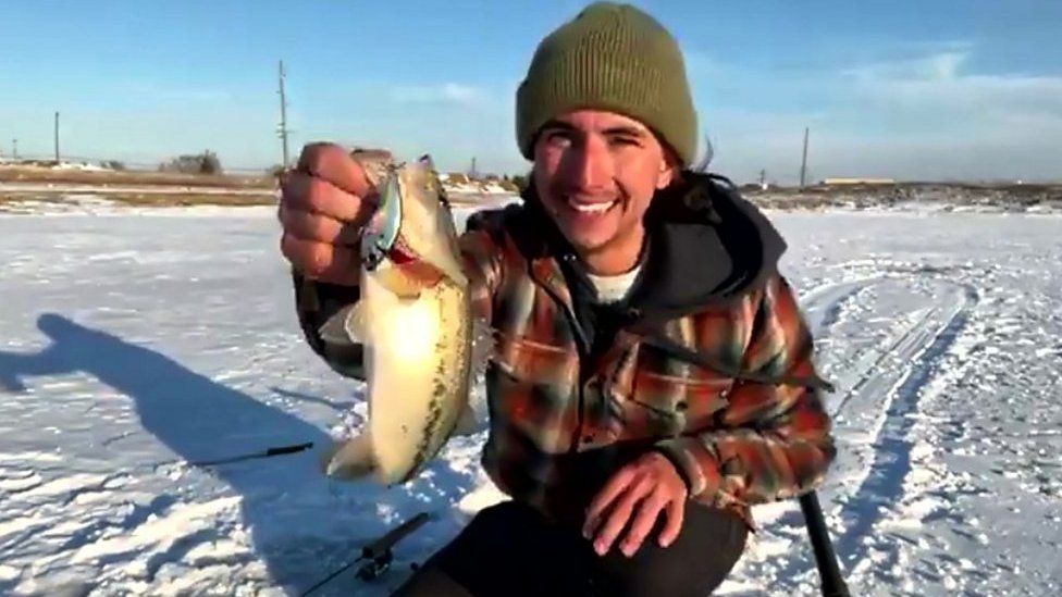 Alex Peric shows off the fish he caught live on TV