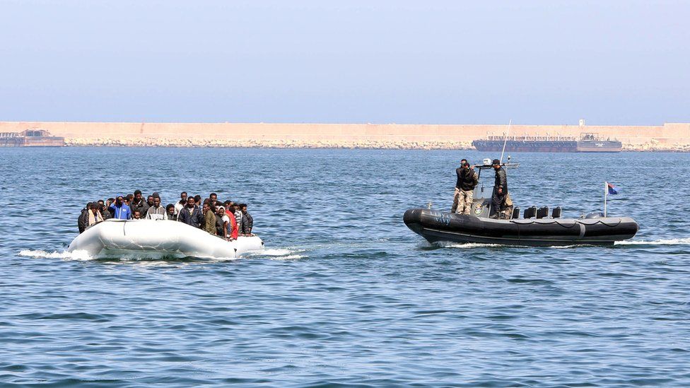 Libyan coast guards escort a boat carrying illegal migrants, who had hoped to set off to Europe with the help of people smugglers from the coastal town of Garabulli, 6 June 2015