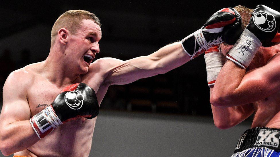 Sean McGlinchey throws a punch in a boxing match