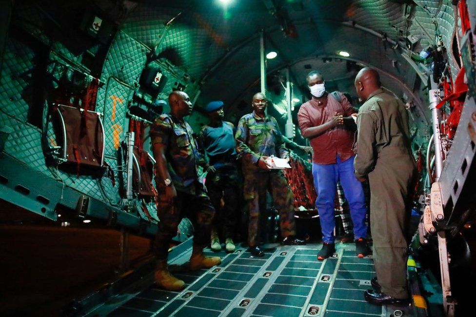 Students disembark from a Kenya Air Force plane carrying 39 students evacuated from Southern Sudan, after it landed at the Jomo Kenyatta International Airport on 24 April 24.