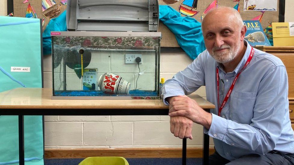 Geoff Carrs posed by an eel tank